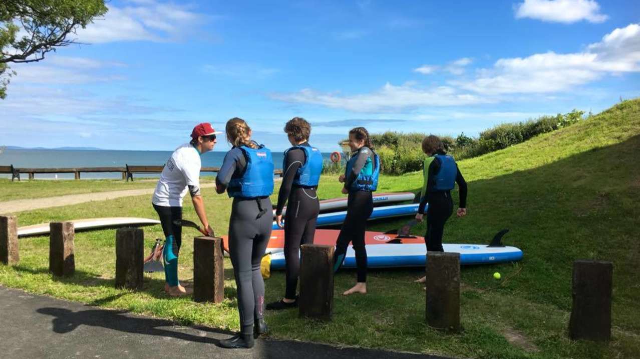 People preparing to Paddle-board at Good Trails in Saundersfoot