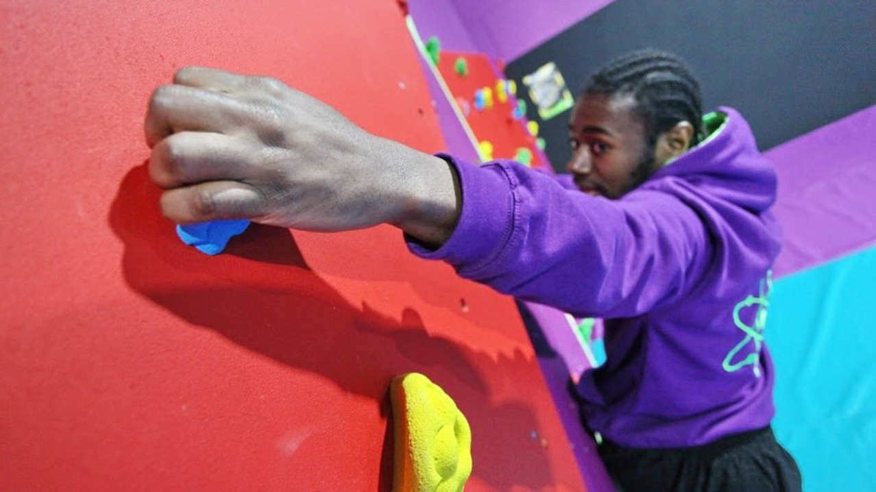 Man climbing at Atom Trampoline Park in Reading Man climbing at Atom Trampoline Park in Reading