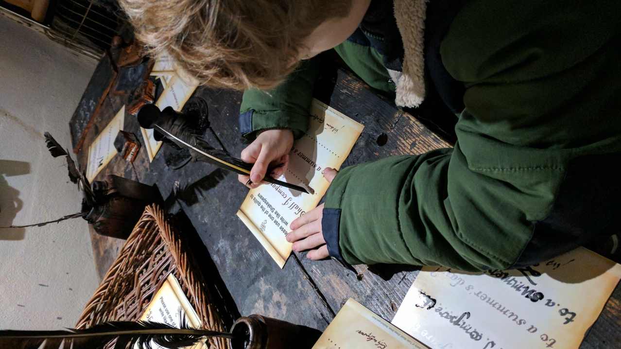 Boy writing letters at Tudor World in Stratford upon Avon Boy writing letters at Tudor World in Stratford upon Avon