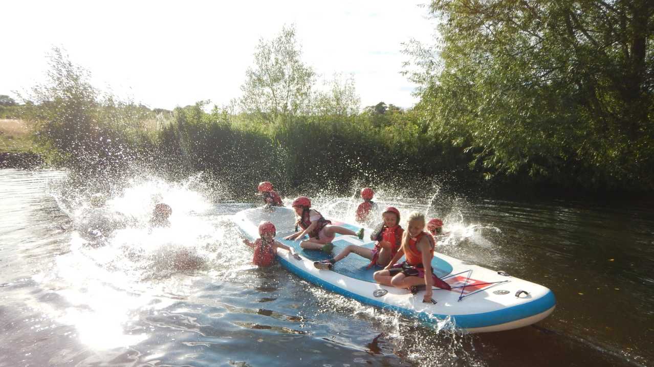 Kids rafting and in lake at Channel Adventure in Taunton Kids rafting and in lake at Channel Adventure in Taunton
