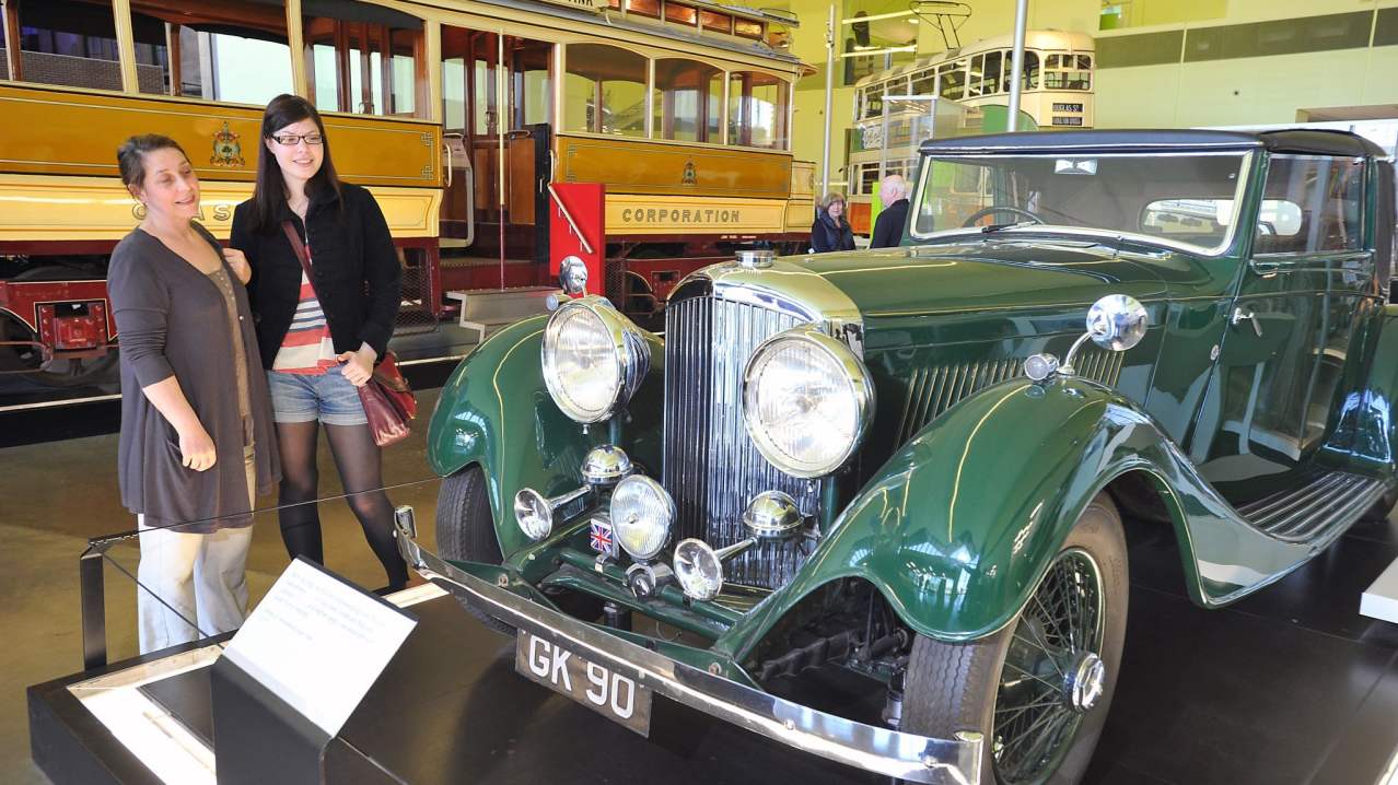 Family looking at classic car at Glasgow Riverside Museum Family looking at classic car at Glasgow Riverside Museum