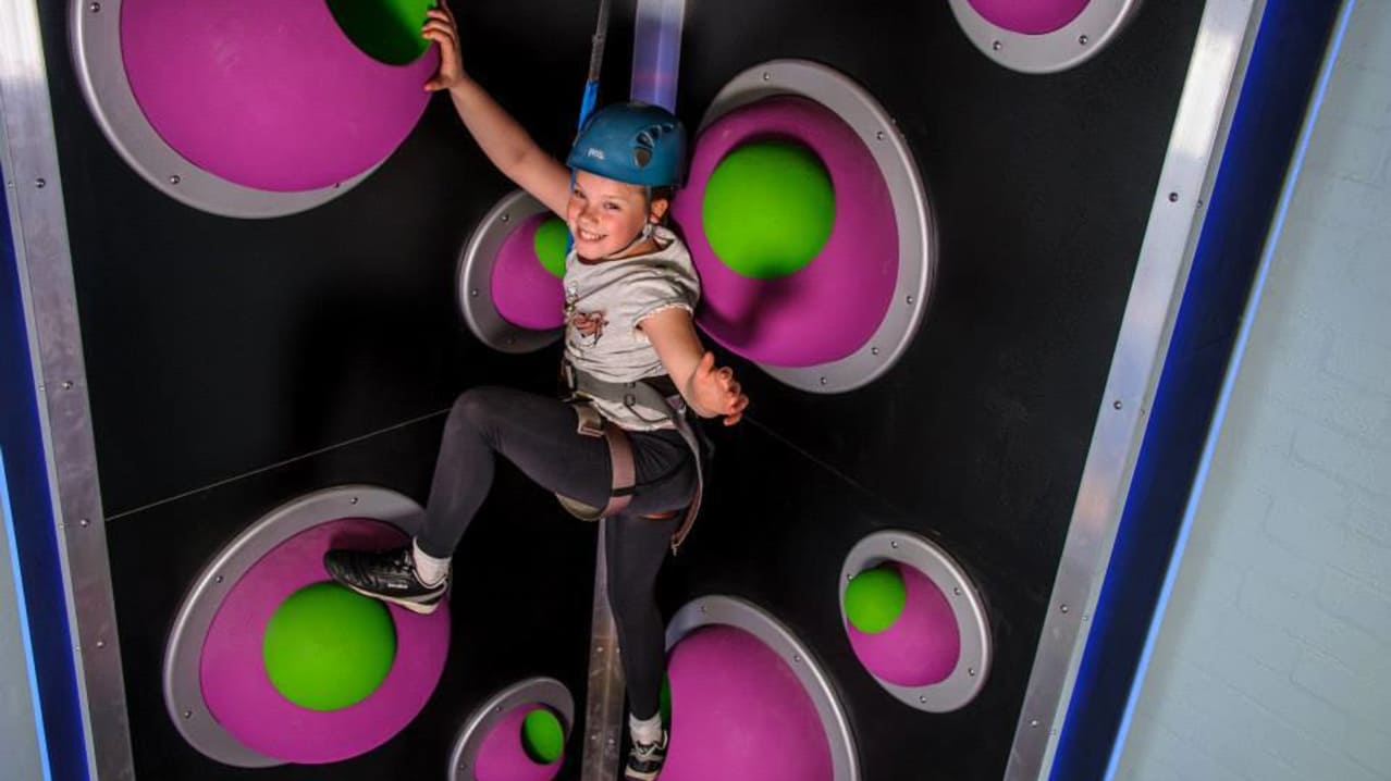 Girl climbing at Lakeland Climbing Centre in Kendal
