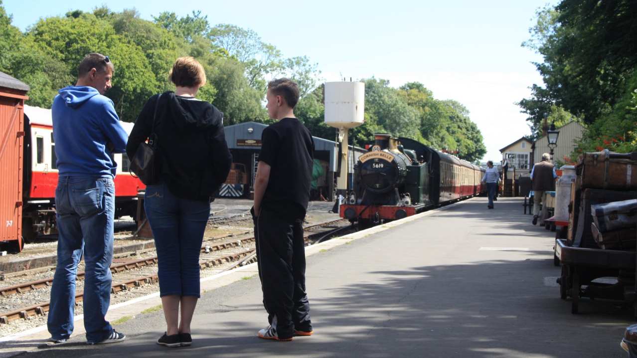 Visitors on platform by trains at Bodmin and Wenford Railway Visitors on platform by trains at Bodmin and Wenford Railway
