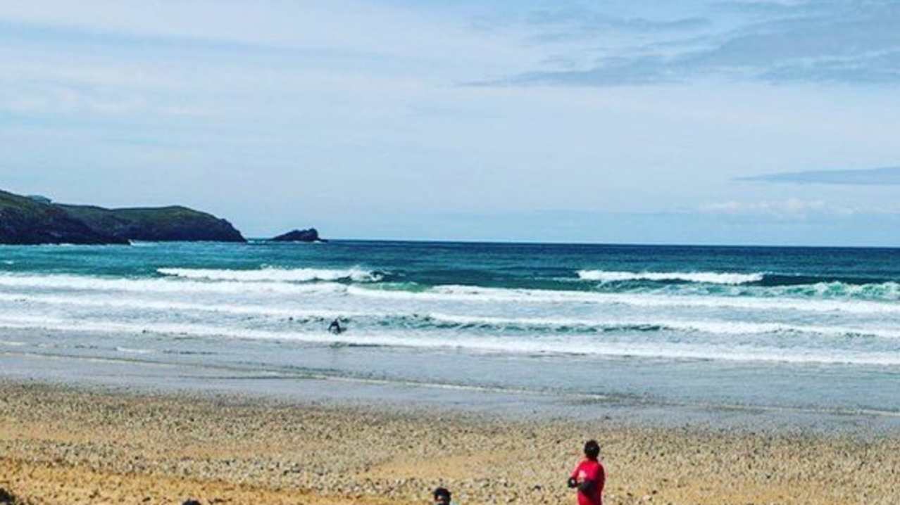 Surfers at Fistral Beach in Newquay Surfers at Fistral Beach in Newquay