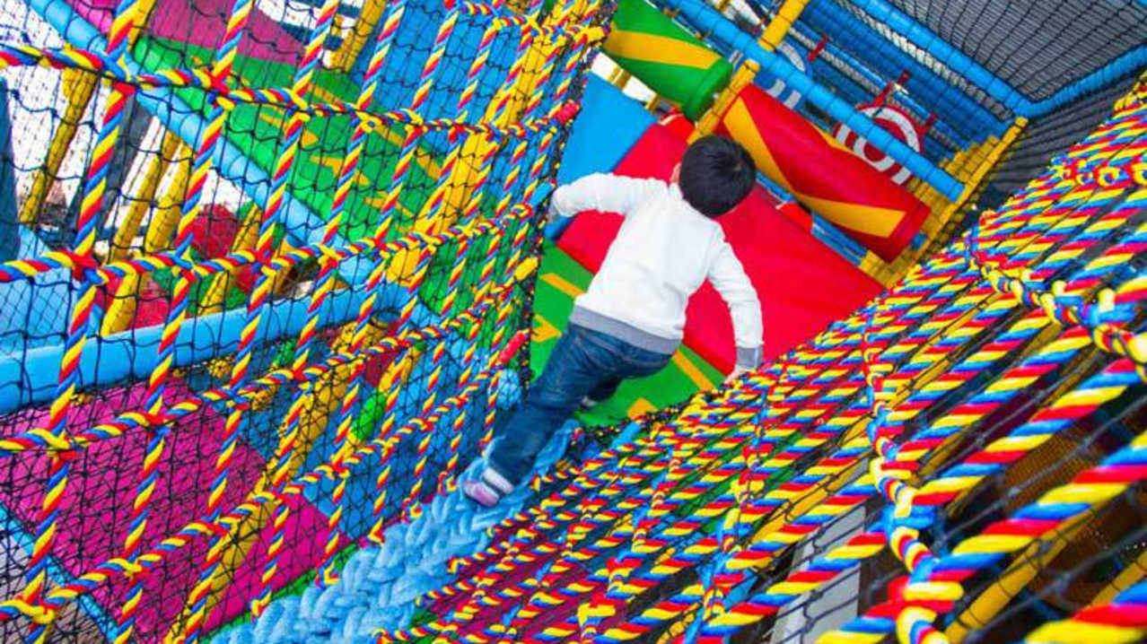 Boy on soft play frame at Teenie Weenies in Birmingham