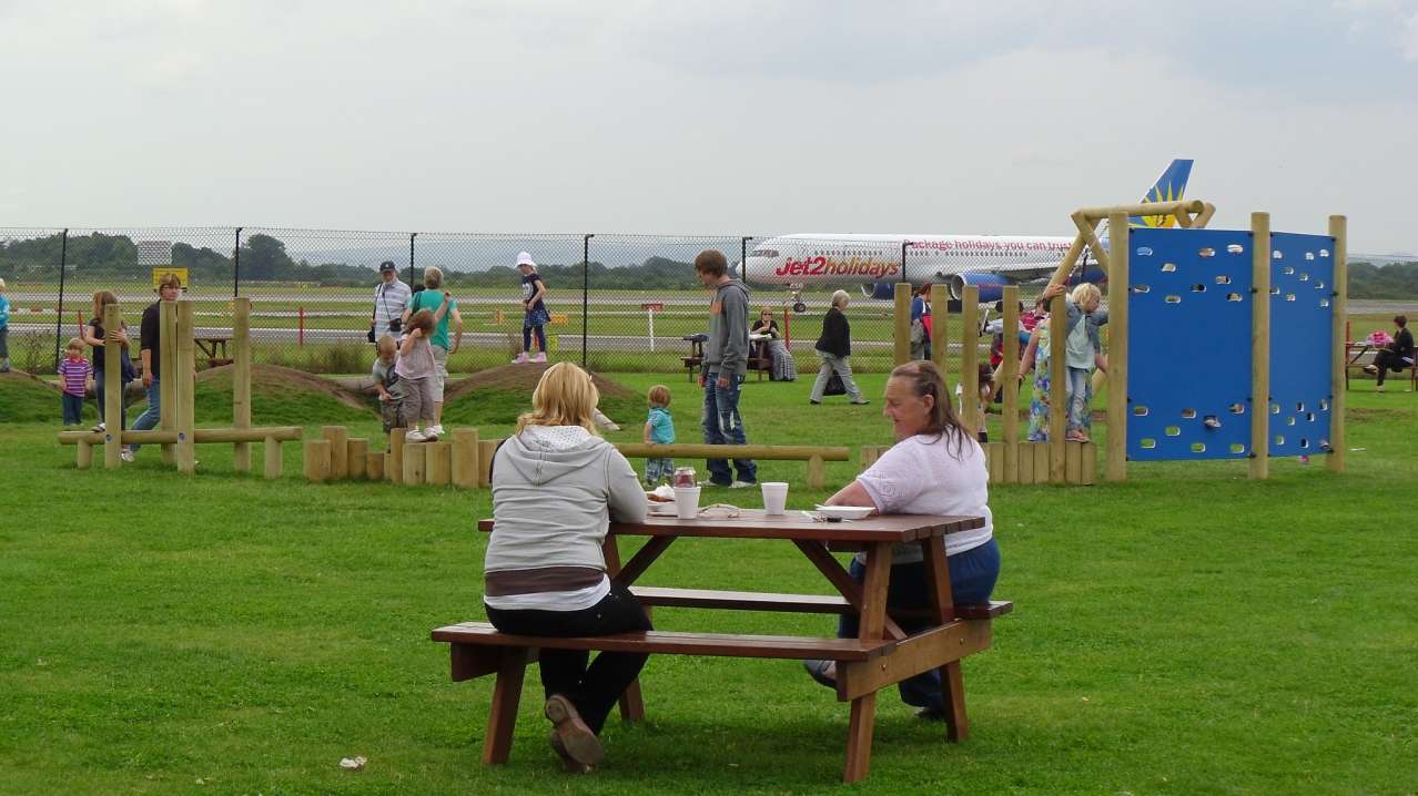Families picnicking and playing at The Runway Visitor Park in Altrincham