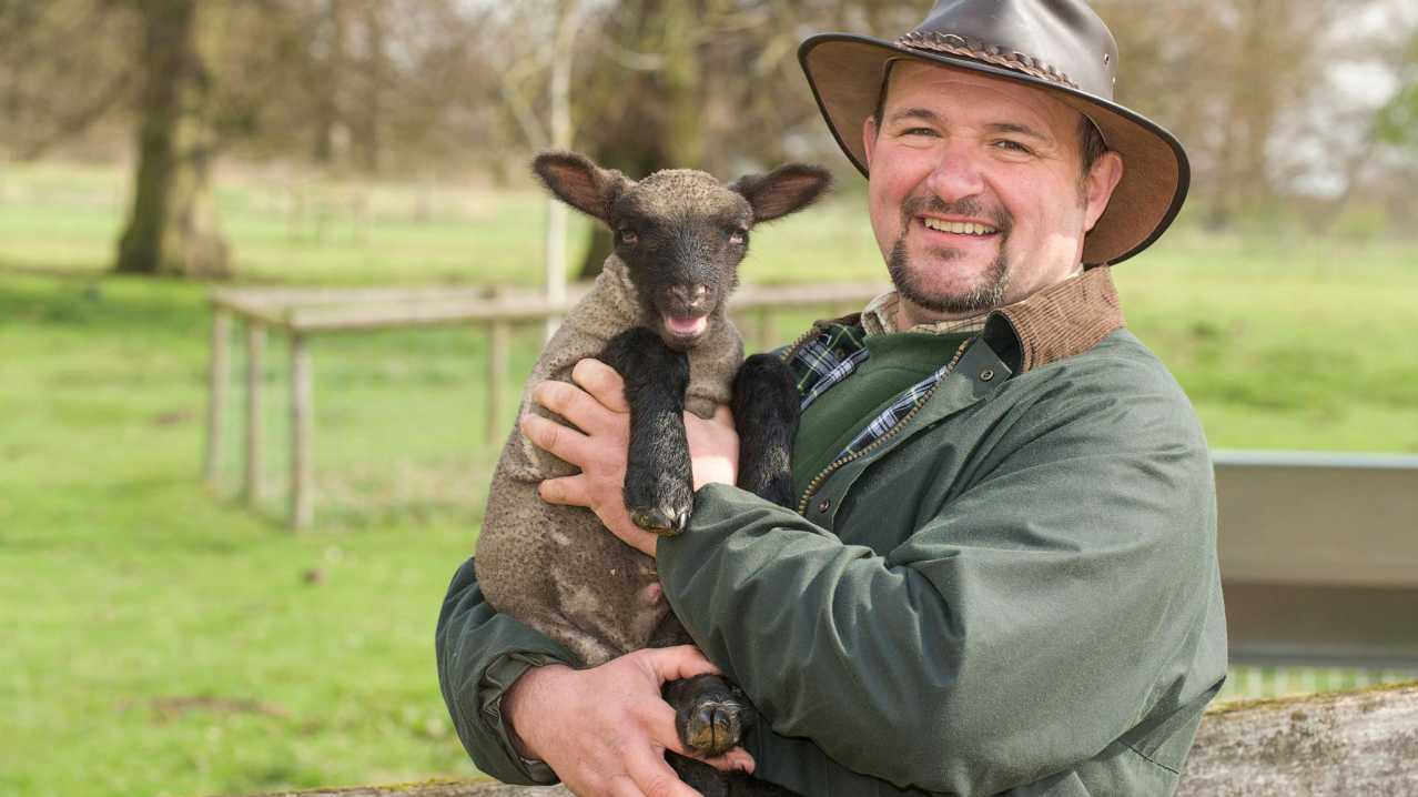 Staff holding lamb at Northycote Farm and Country Park in Wolverhampton