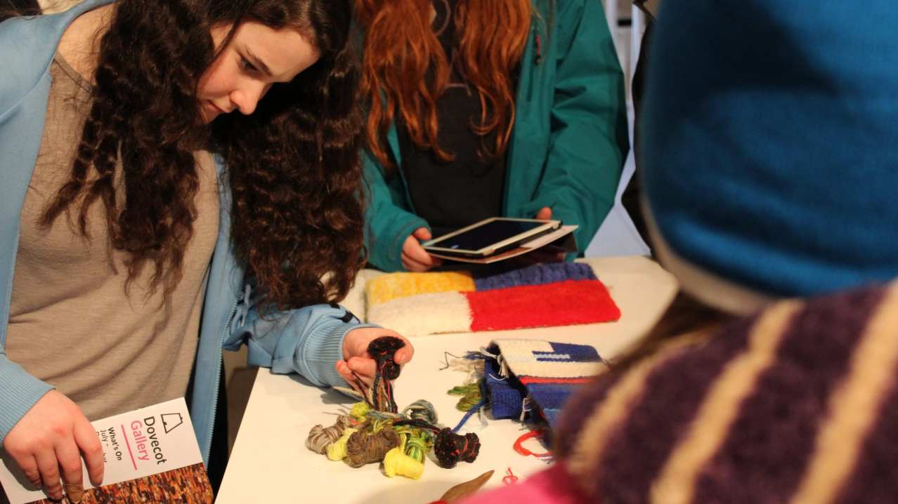 Girl looking at threads at Dovecot Studios in Edinburgh