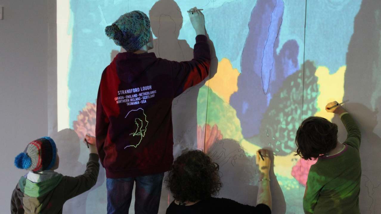 People drawing on wall at Dovecot Studios in Edinburgh