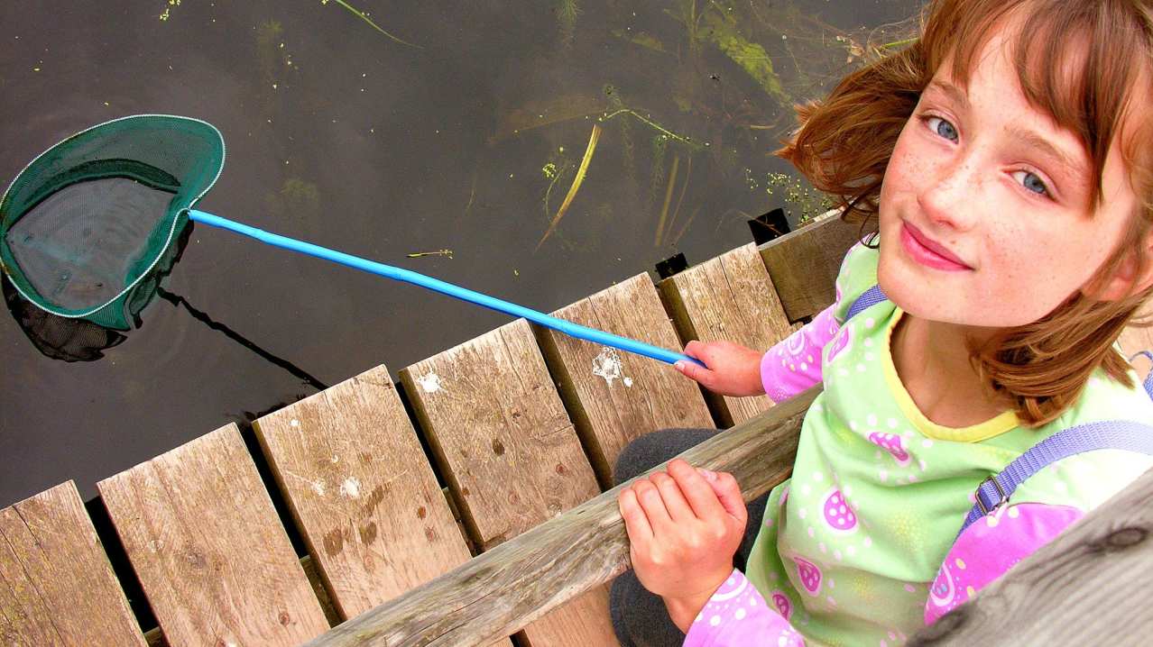 Girl with fishing net at Shropshire Hills Discovery Centre in Craven Arms Girl with fishing net at Shropshire Hills Discovery Centre in Craven Arms
