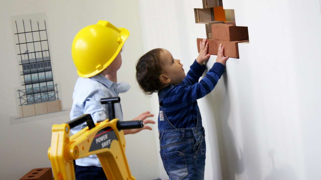 Kids roleplaying construction at Tots Town in Norwich Kids roleplaying construction at Tots Town in Norwich