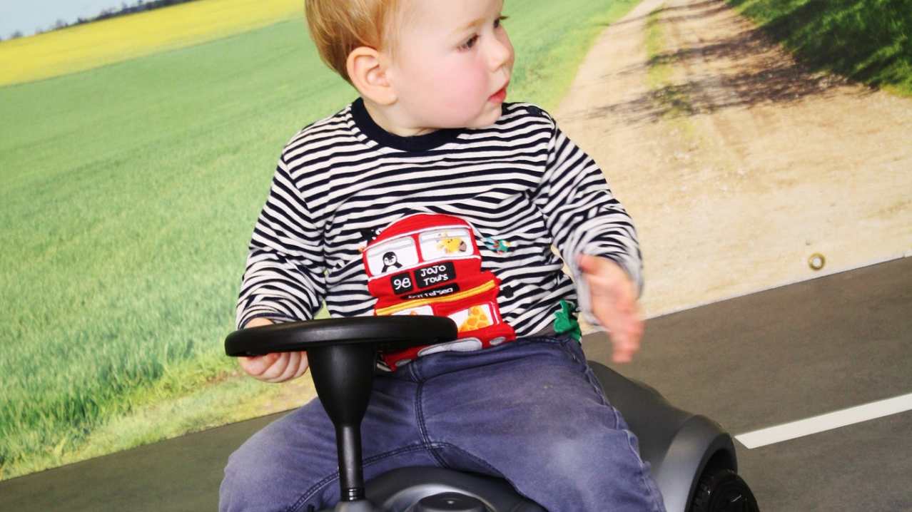 Boy on toy car at Tots Town in Norwich Boy on toy car at Tots Town in Norwich