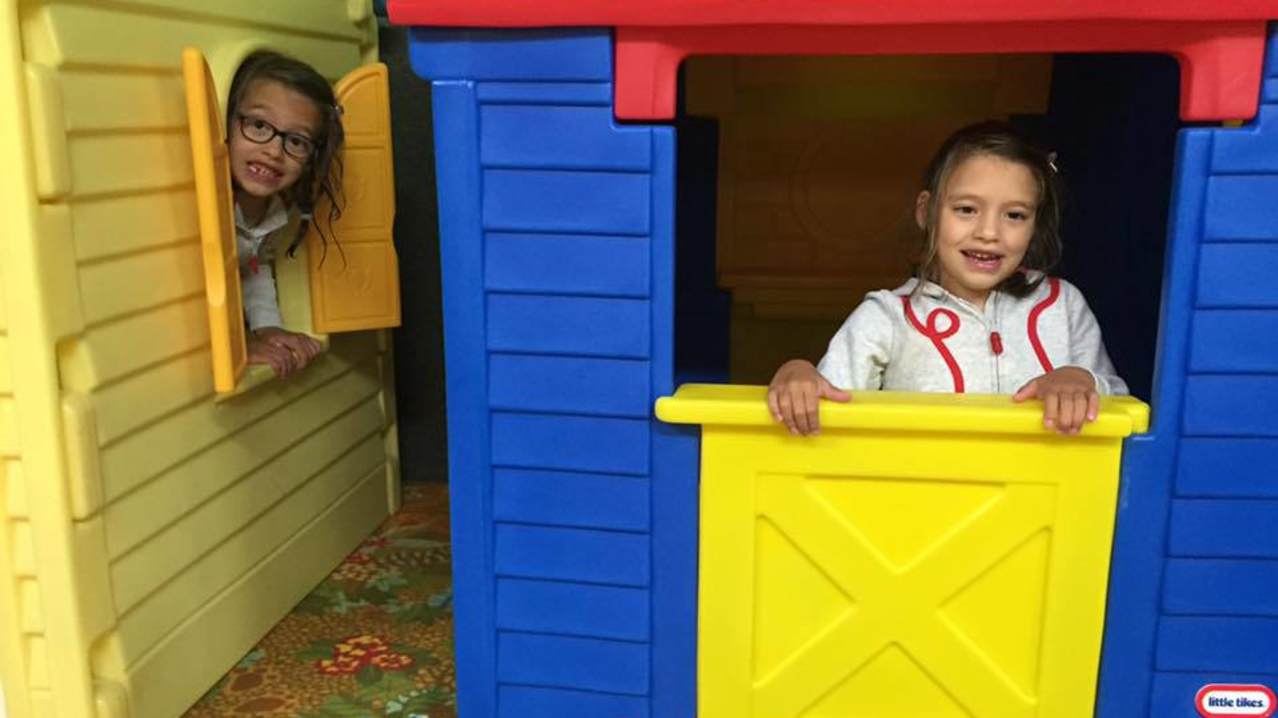 Girls playing in fun house at Springfields Fun Park and Pony Centre in Newquay
