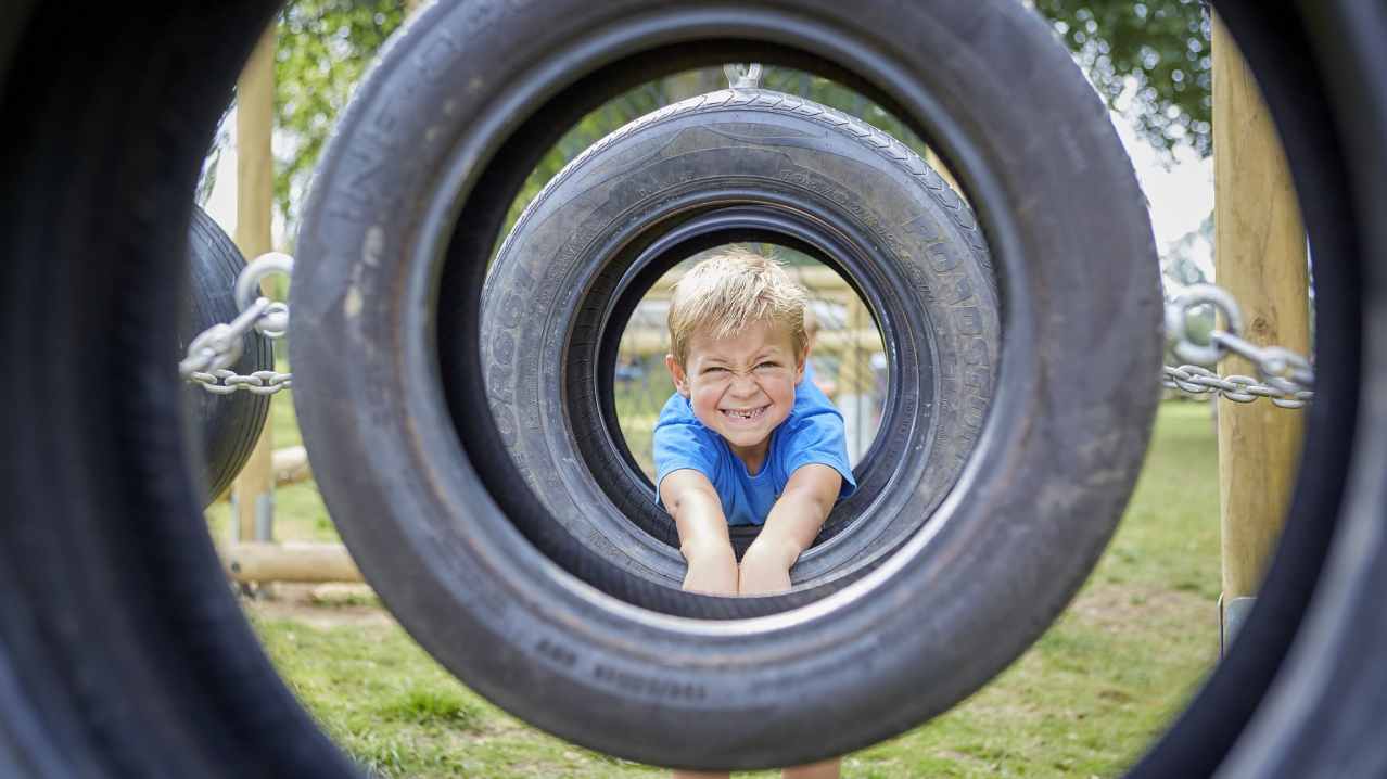 Boy on assault course at Sudeley Castle in Winchcombe Boy on assault course at Sudeley Castle in Winchcombe