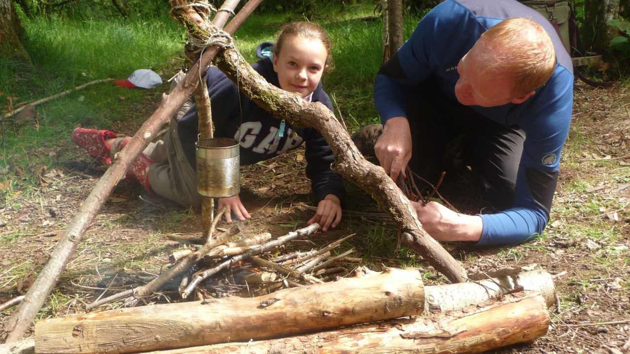 Dad and daughter cooking outdoor at Do It Outdoors in Comrie