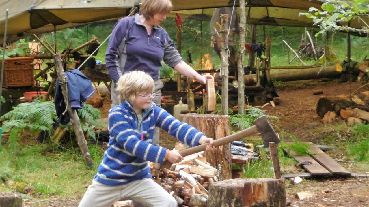 Boy cutting wood at Do It Outdoors in Comrie