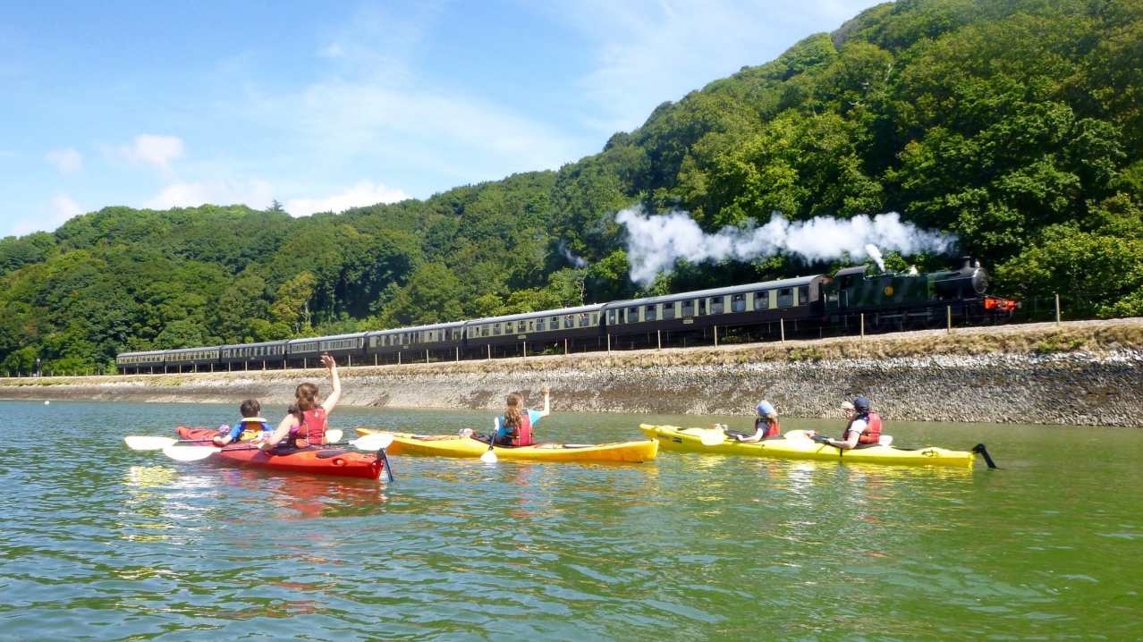 People in kayaks at Sea Kayak Devon in Dartmouth People in kayaks at Sea Kayak Devon in Dartmouth