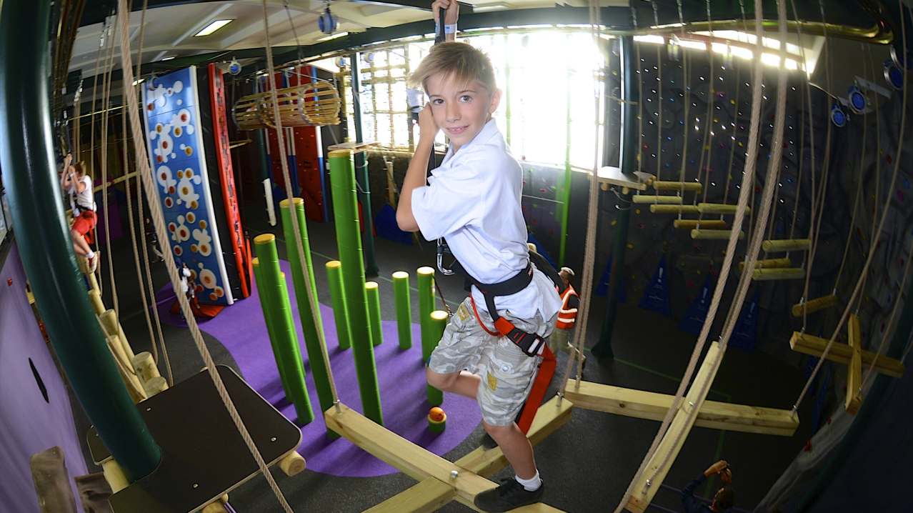 Boy on high rope course at Clip n Climb Dundonald in Belfast