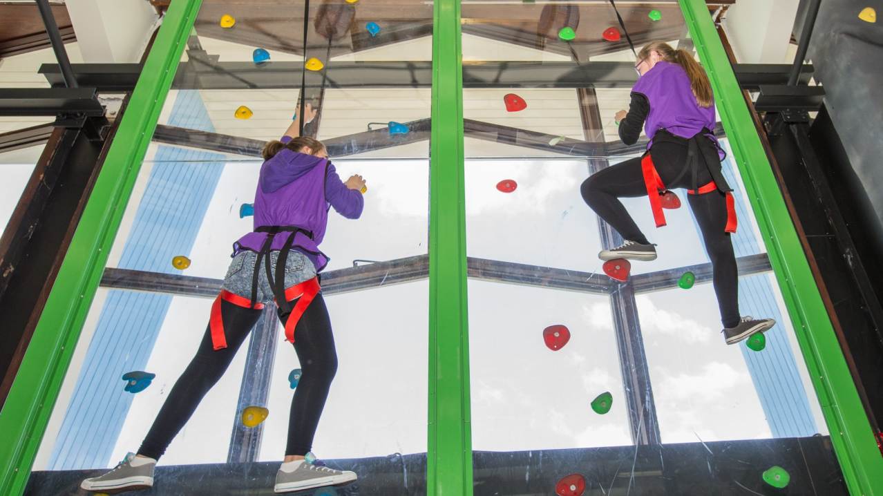 Girls climbing at Clip n Climb Dundonald in Belfast