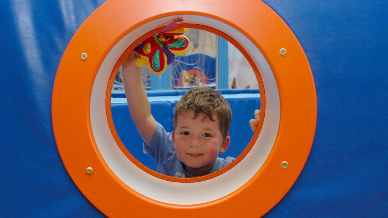 Boy playing on soft play frame at Rugrats and Half Pints Indoor Play Centre in Banbury