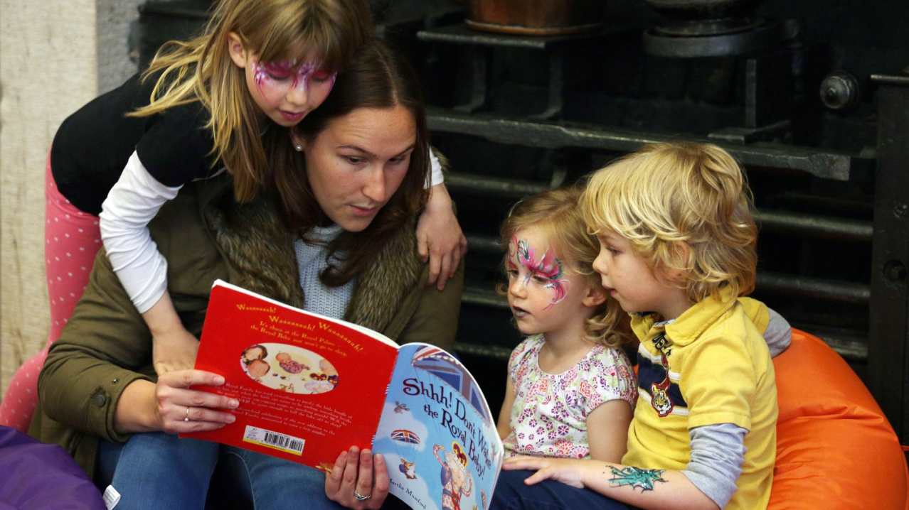 Family reading book at Palace of Holyroodhouse in Edinburgh