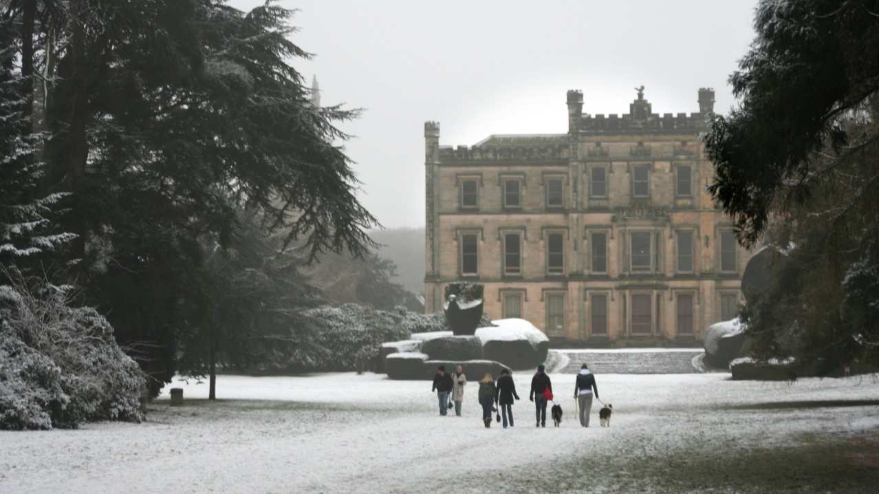 People walking through snow at Elvaston Castle 