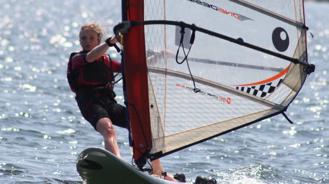 Girl wind surfing at Hollingworth Lake Activity Centre in Littleborough Girl wind surfing at Hollingworth Lake Activity Centre in Littleborough