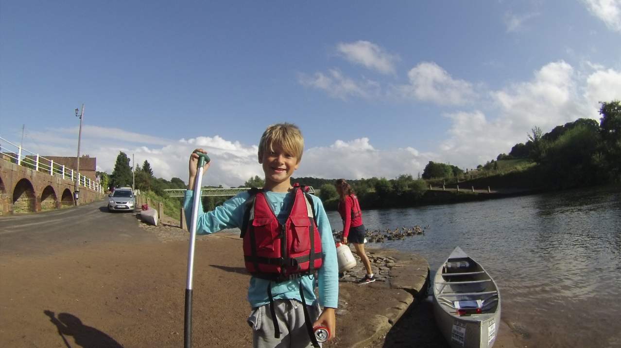 Boy by canoe at The Sun Valley Canoeing Co in Bridgnorth Boy by canoe at The Sun Valley Canoeing Co in Bridgnorth