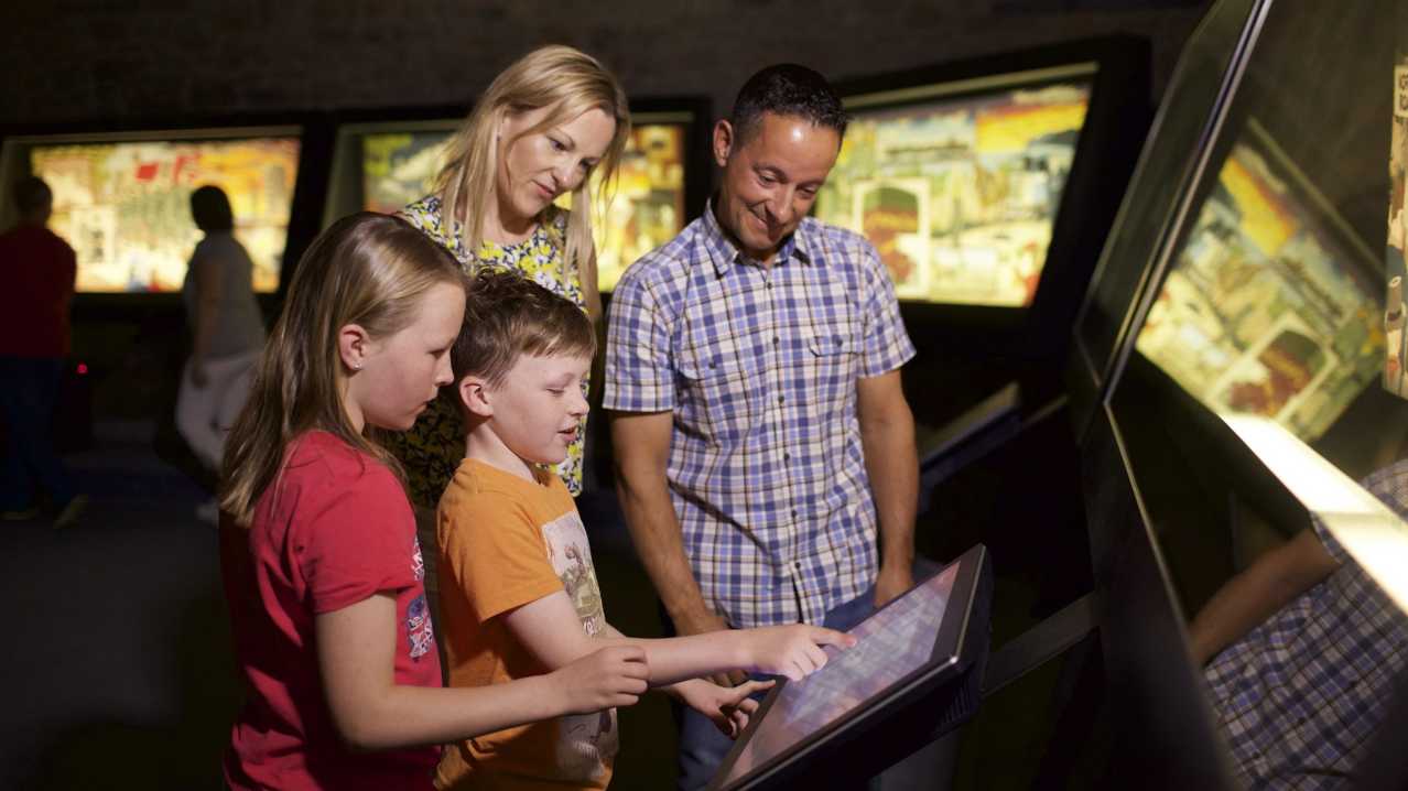 Family looking at interactive screen at Maritime Museum in Jersey