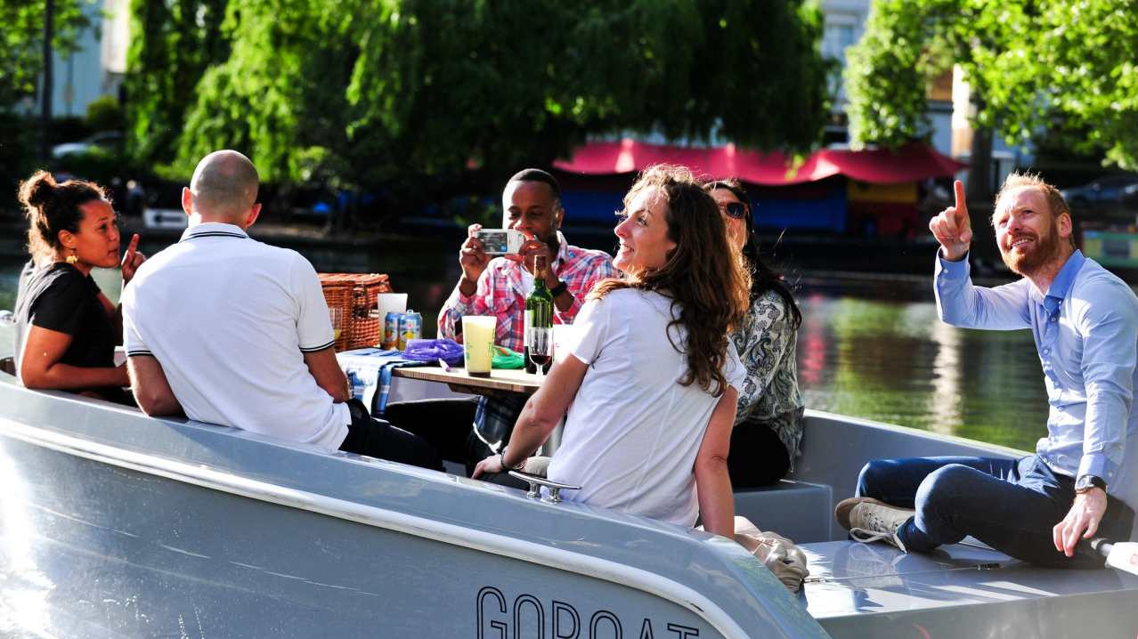 Visitors picnicking on boat at GoBoat London Visitors picnicking on boat at GoBoat London
