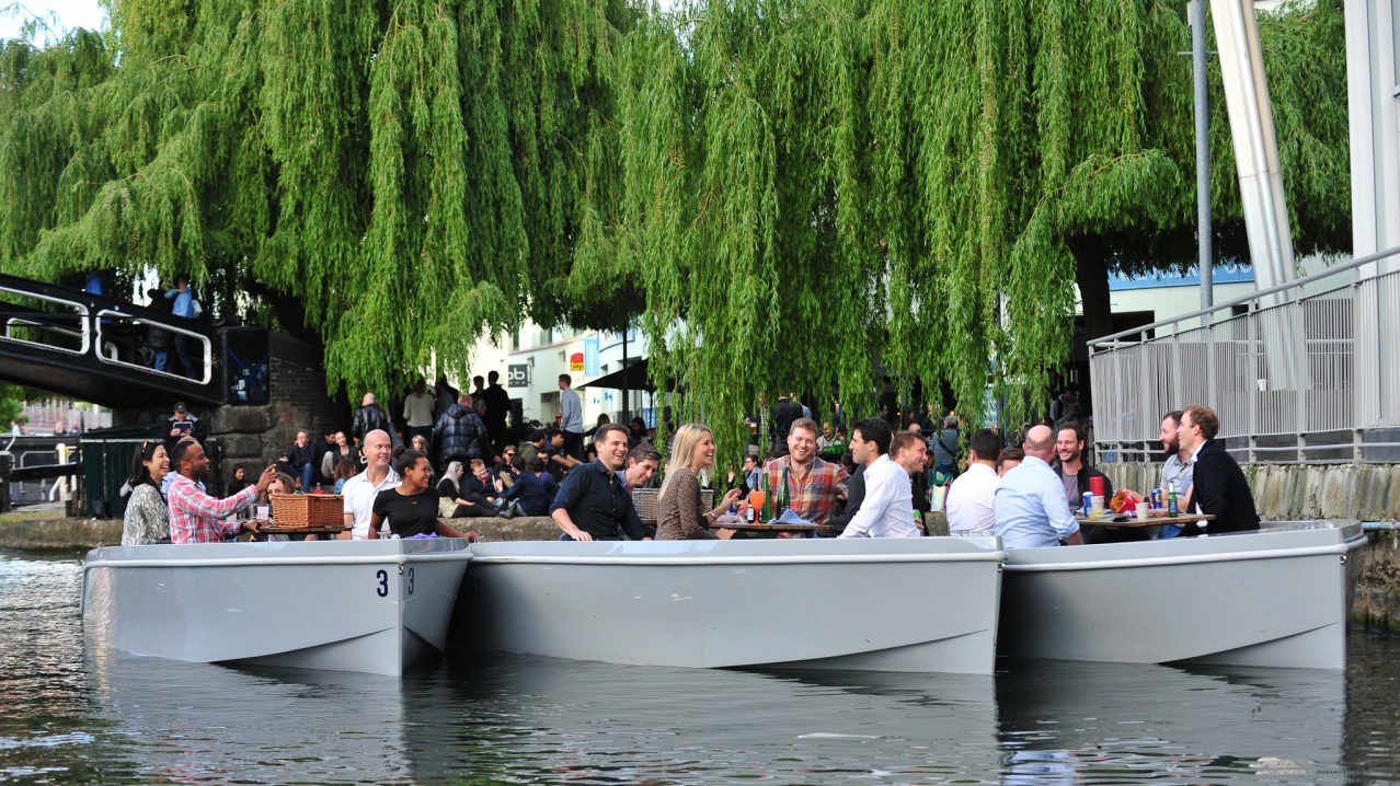 Visitors picnicking on boats at GoBoat London Visitors picnicking on boats at GoBoat London
