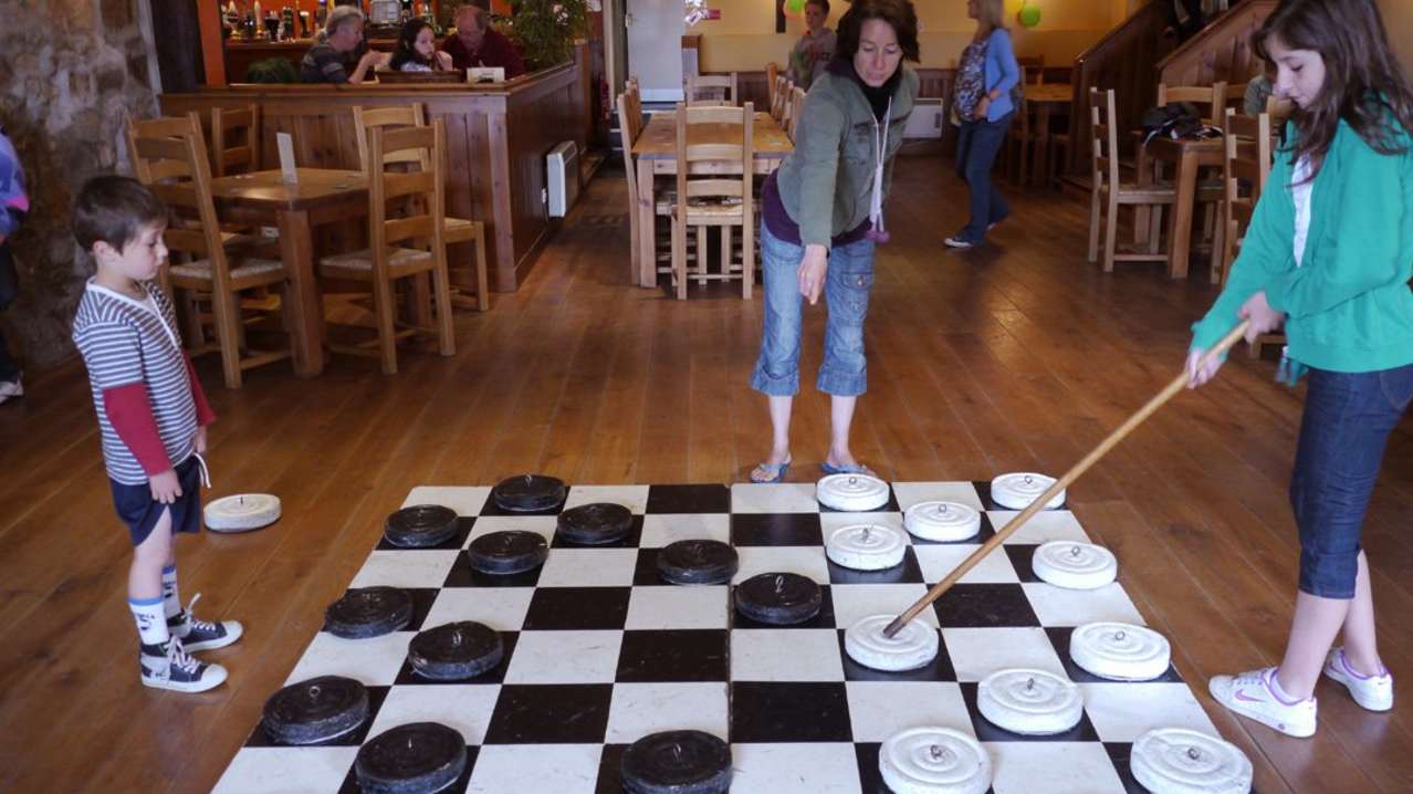 Visitors playing giant draughts at Country Skittles in Hayle