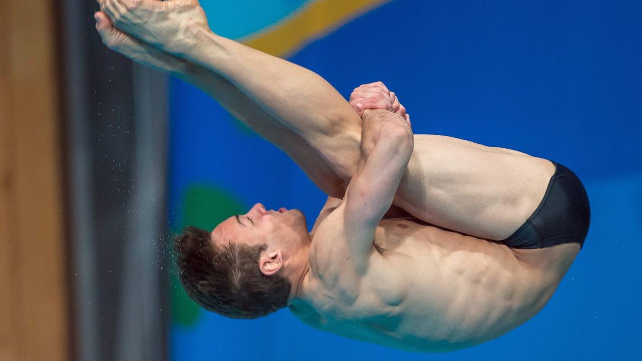 Man diving at London Aquatics Centre in London