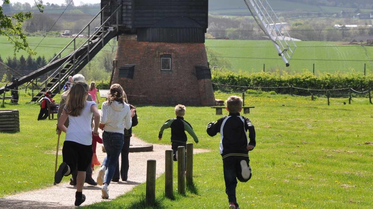 Kids run to windmill at Avoncroft Museum of Historic Buildings in Bromsgrove