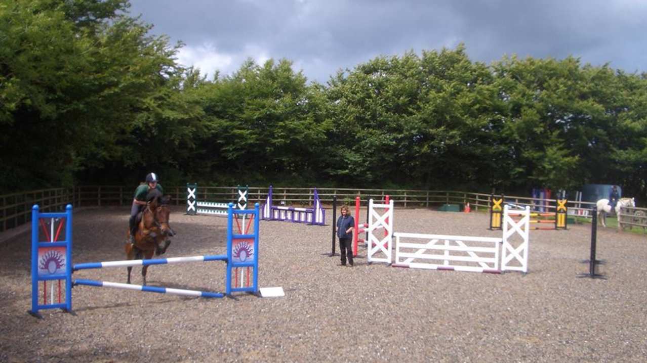 Horse and rider jumping at Dean Riding Stables in Parracombe Horse and rider jumping at Dean Riding Stables in Parracombe