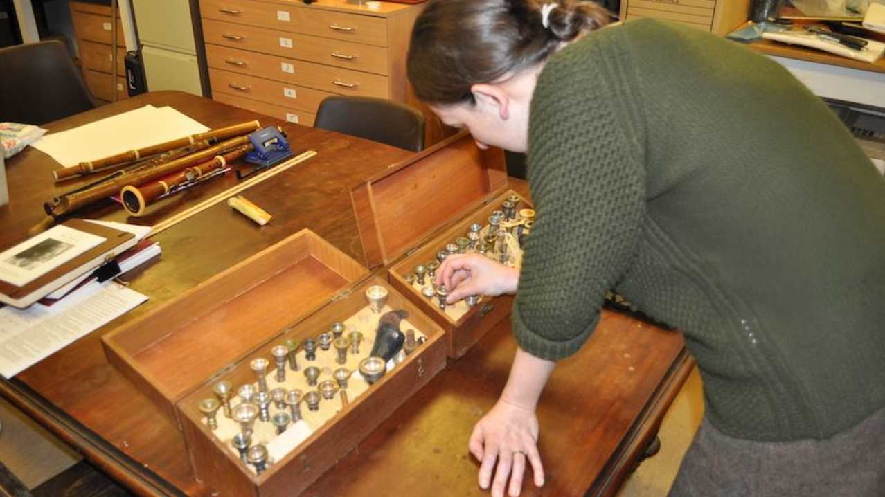 Woman looking at exhibit at Bates Collection of Musical Instruments in Oxford Woman looking at exhibit at Bates Collection of Musical Instruments in Oxford