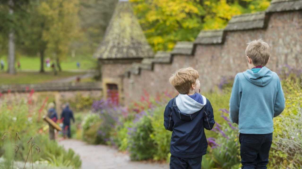 Two kids walking in the gardens at Knightshayes Gardens, photo credit National Trust/Chris Lacey