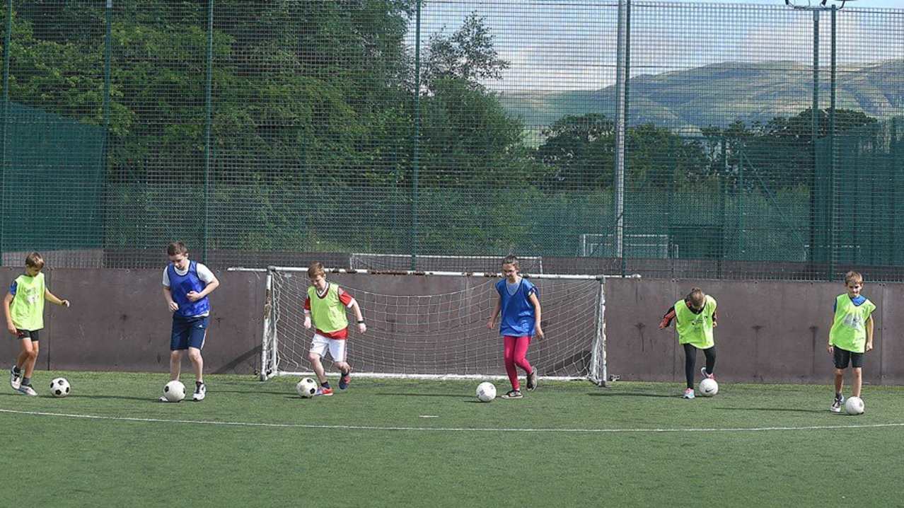 Kids playing football at The Peak in Stirling Kids playing football at The Peak in Stirling