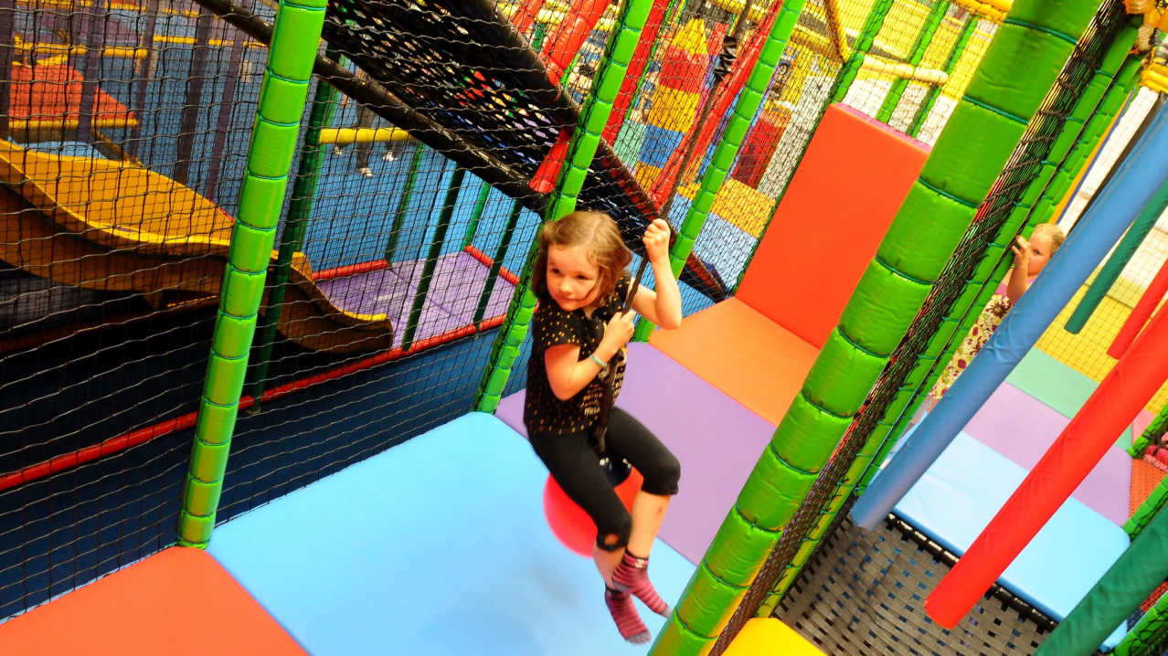 Girl playing on soft play frame at Tigers Indoor Play in Daventry Girl playing on soft play frame at Tigers Indoor Play in Daventry