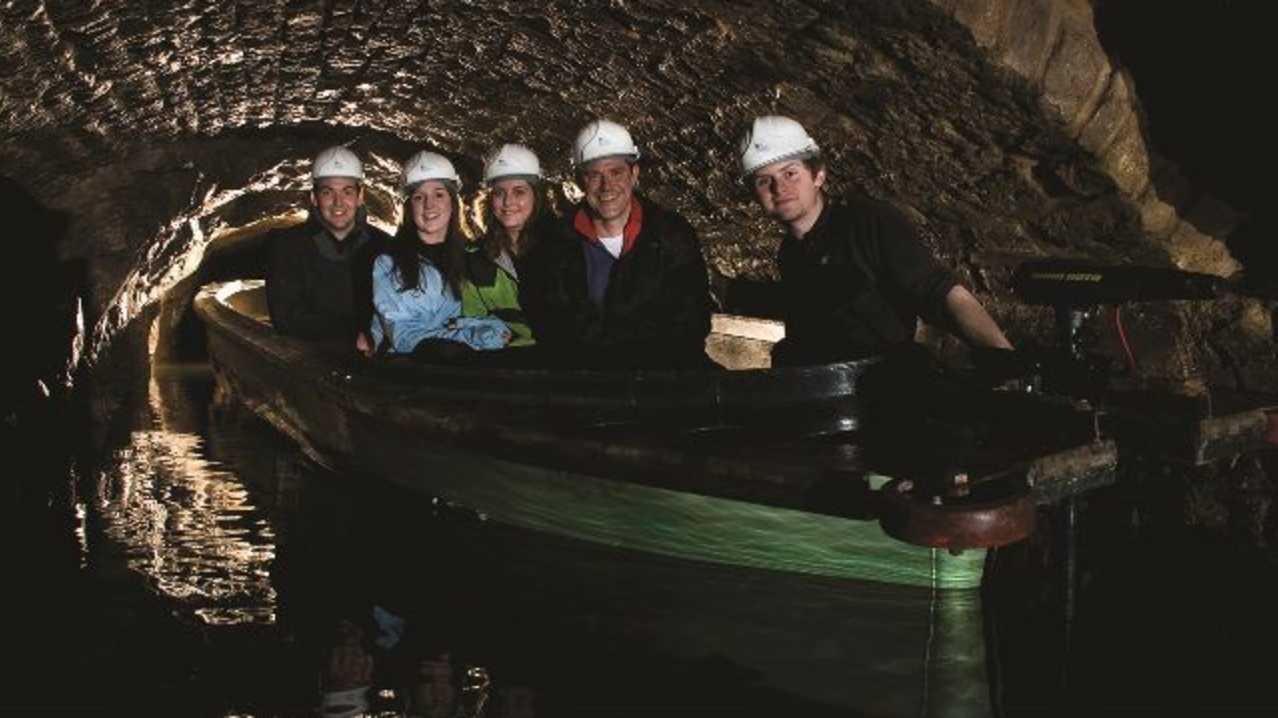People on canal boat at Speedwell Cavern in Castleton
