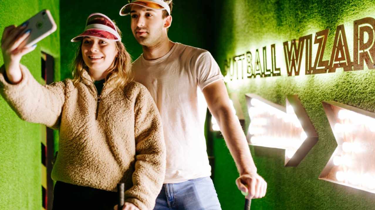 Two people taking a photo at Putt Club Crazy Golf in Hull Two people taking a photo at Putt Club Crazy Golf in Hull
