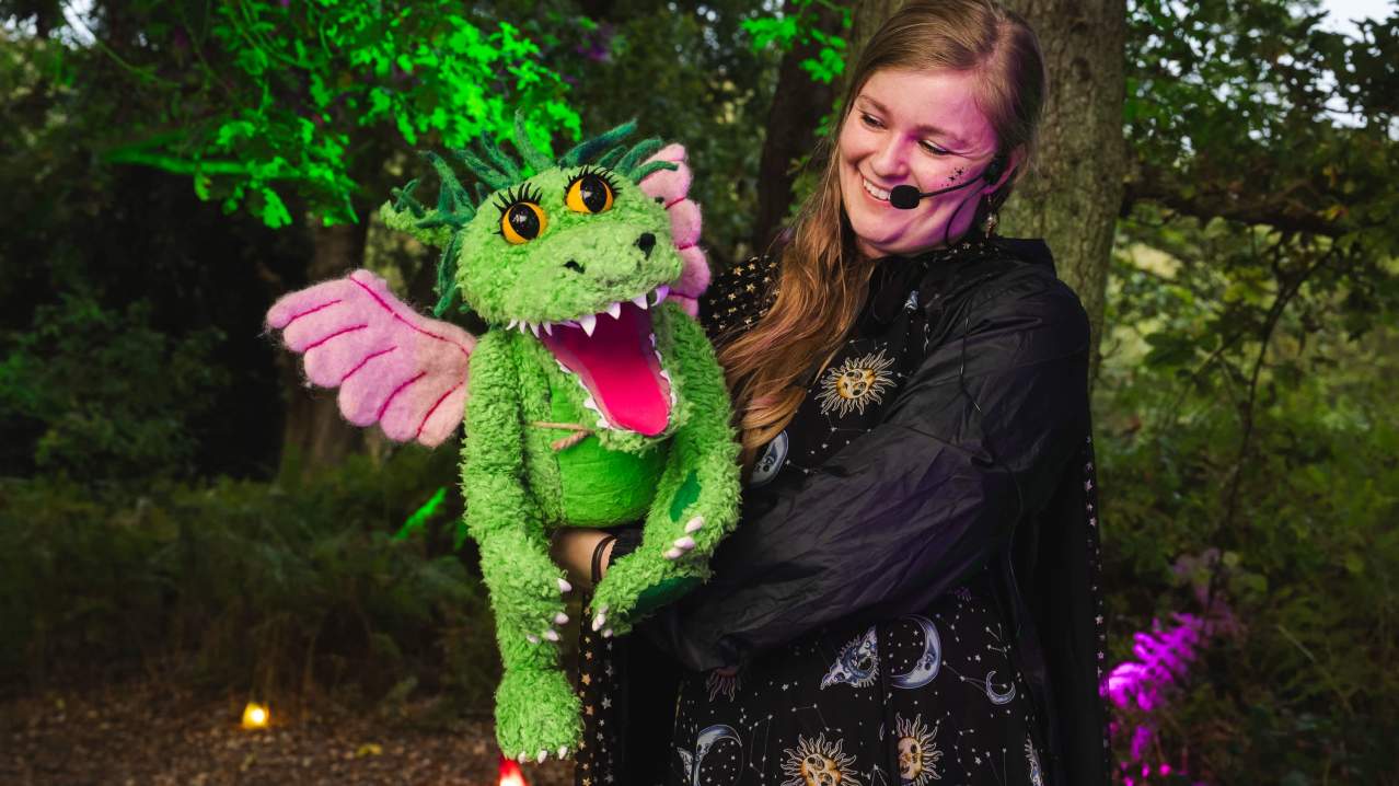woman holding bewilderwood character