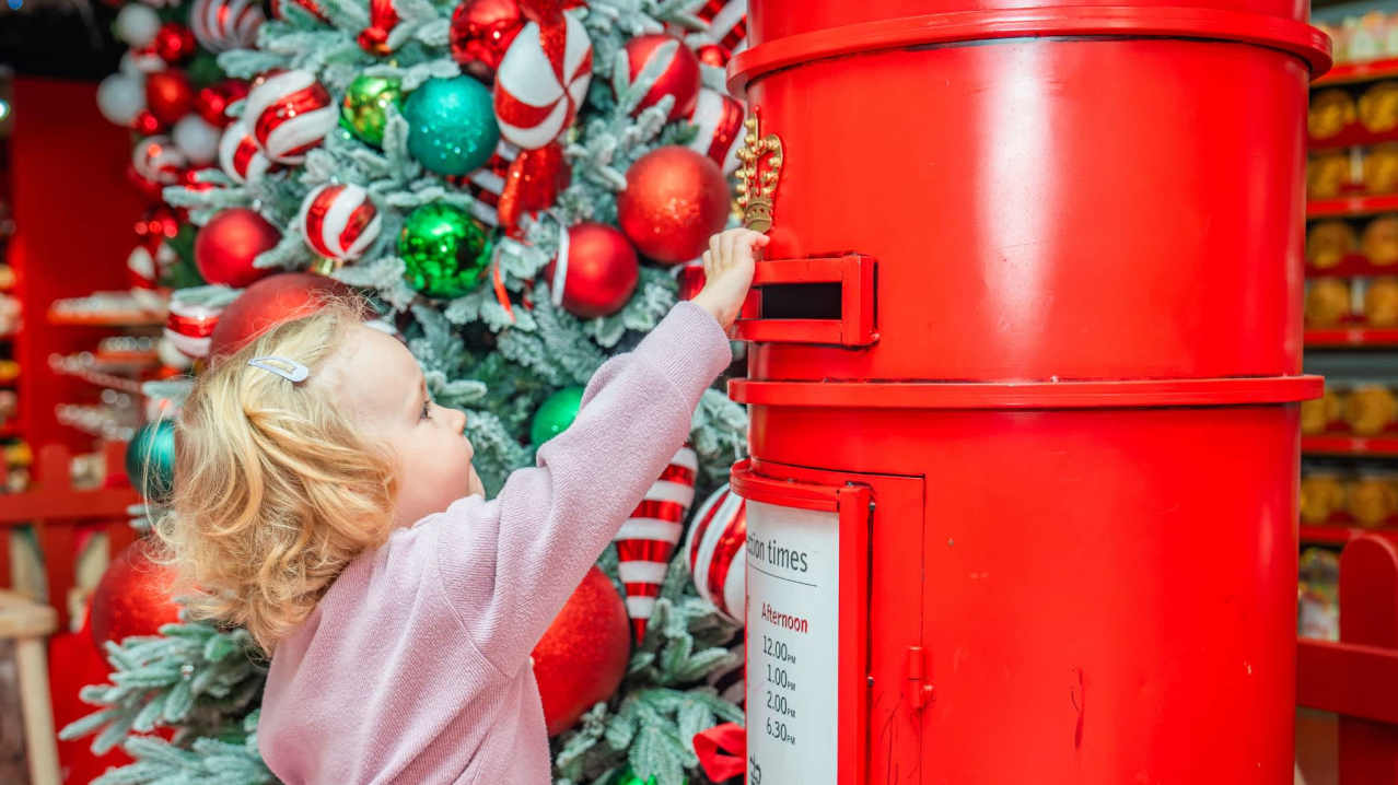 Child posting letter to santa