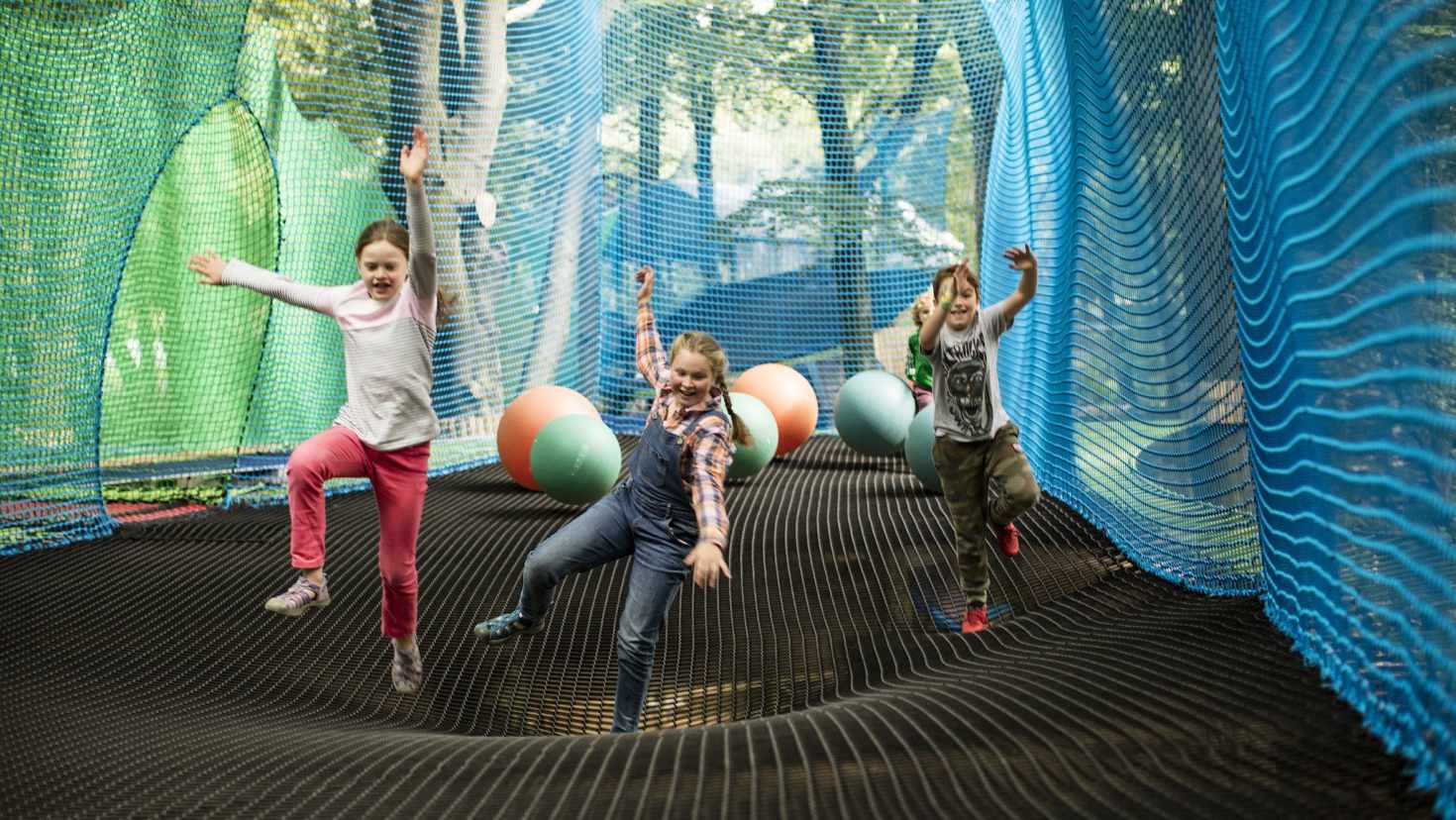 Children jumping in nets at Treetop Trek Manchester