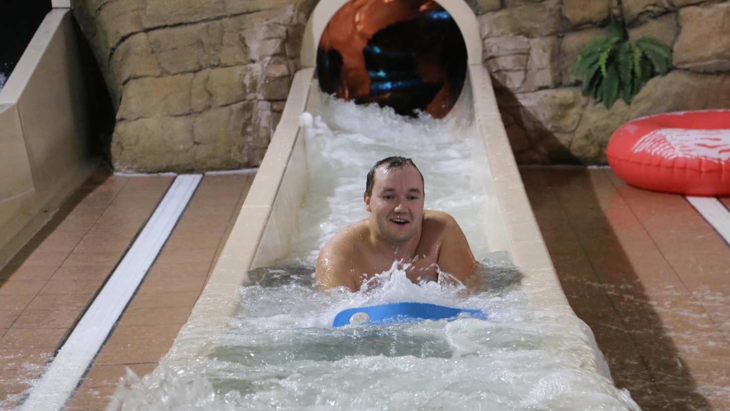 Man on water slide at Sandcastle Waterpark in Blackpool