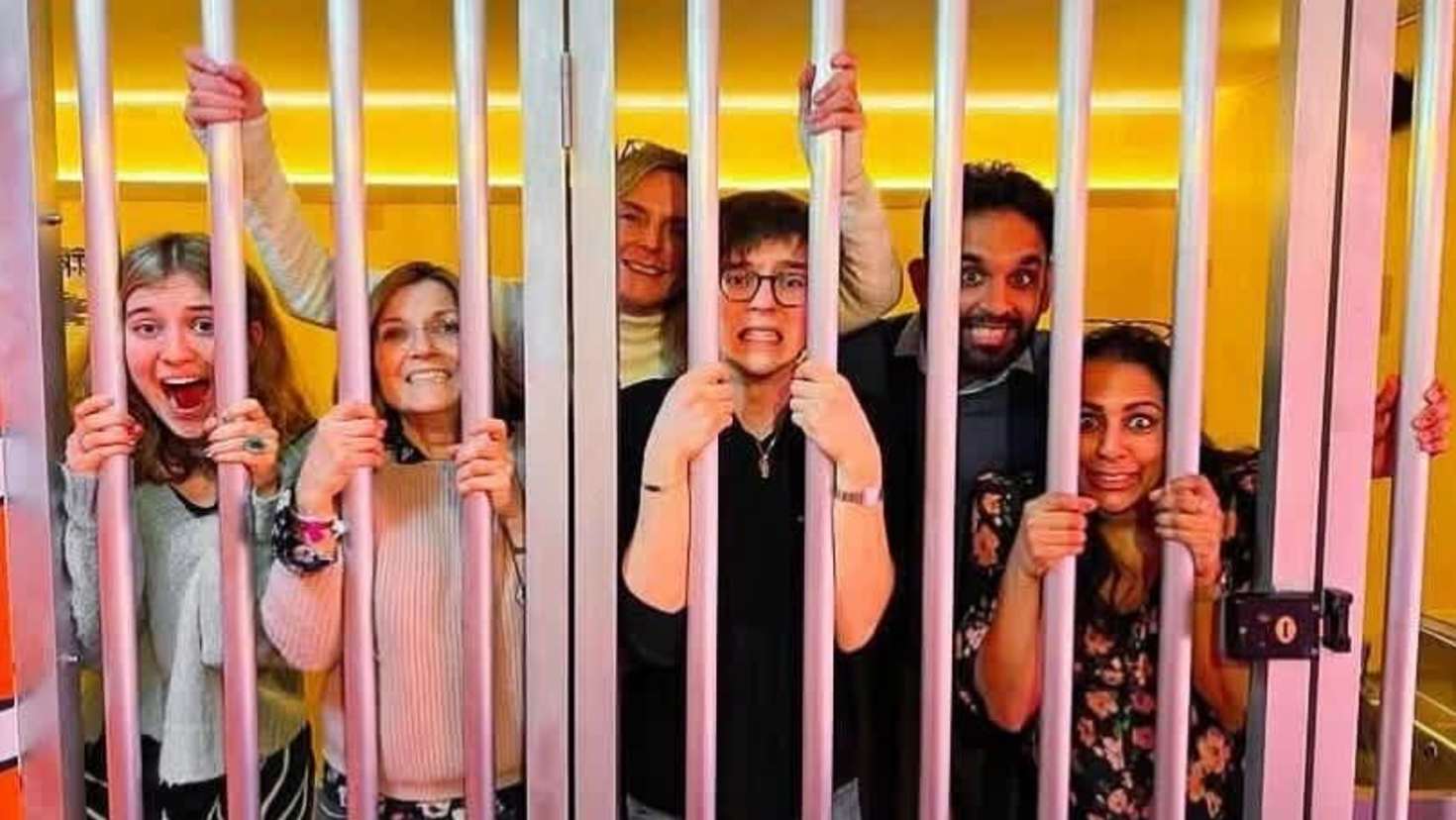 people stuck behind jail bars in monopoly lifesized