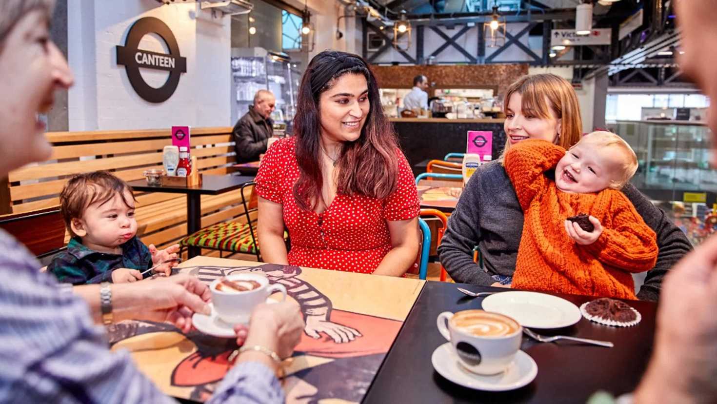 Families enjoying coffee and cake at the Canteen café in the London Transport Museum.