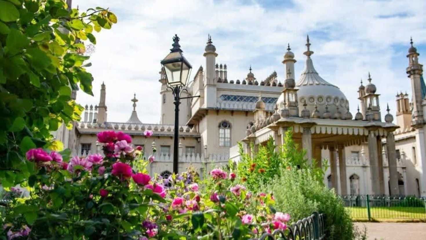 royal pavilion garden shot with pic flowers in the foreground and Royal pavilion in the background