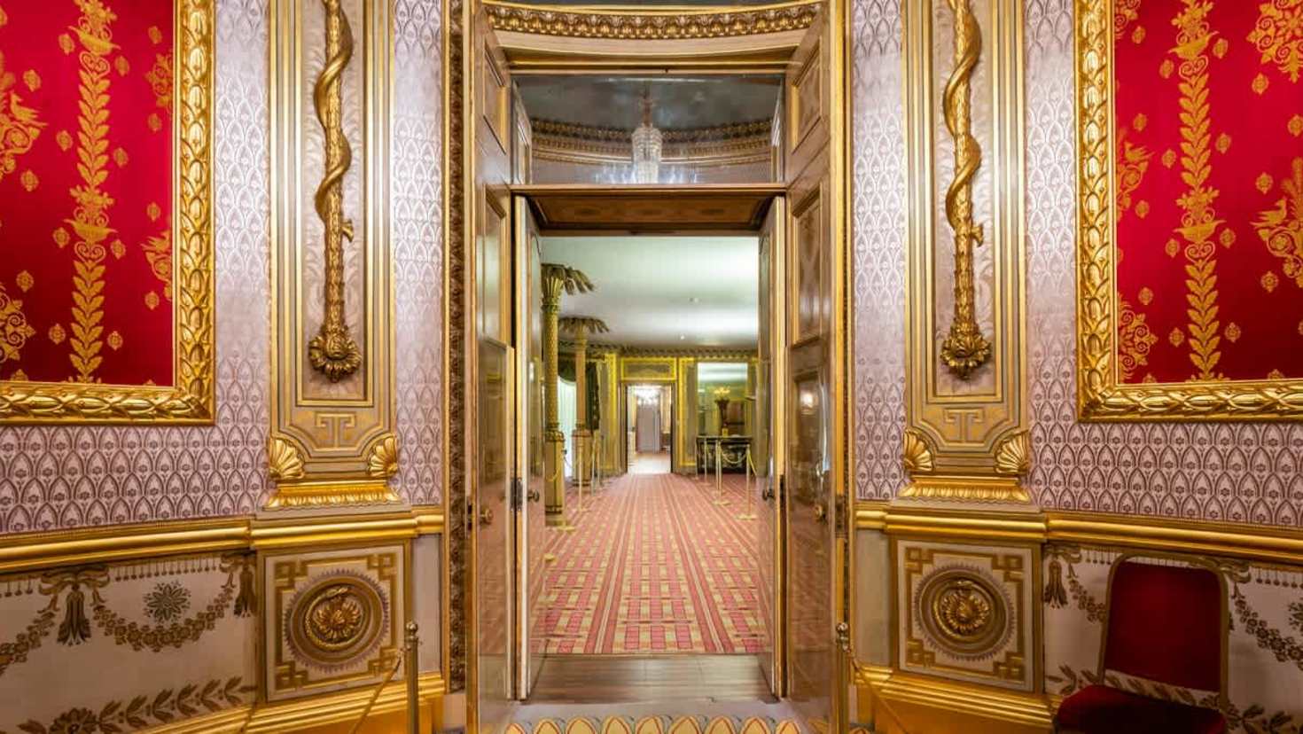 gold and red embellished room and hallway