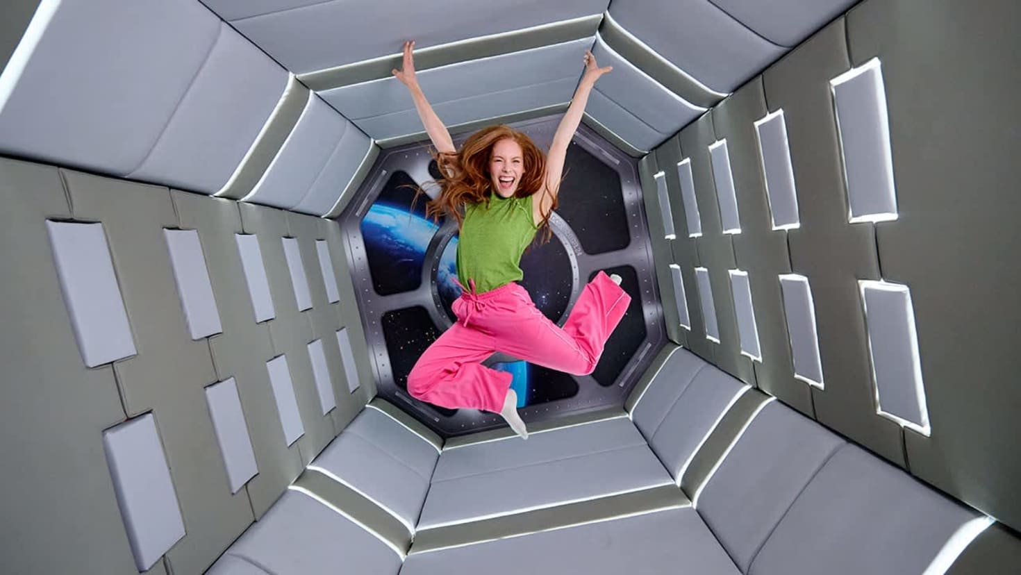 A girl floats mid-air in a zero-gravity space pod illusion at Paradox Museum London, surrounded by padded walls and a cosmic portal behind her. A girl floats mid-air in a zero-gravity space pod illusion at Paradox Museum London, surrounded by padded walls and a cosmic portal behind her.